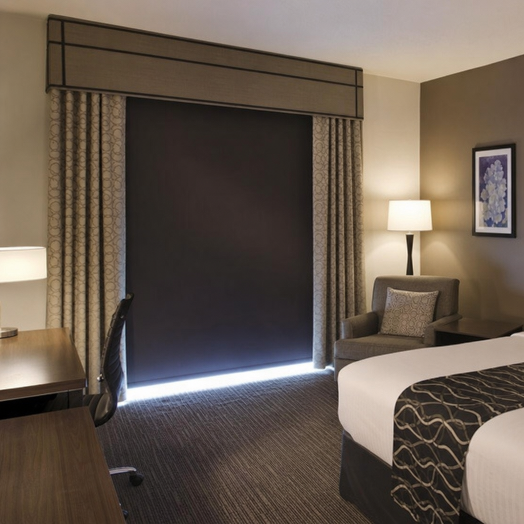 Hotel room interior showing heavy duty blackout shades and custom drapery